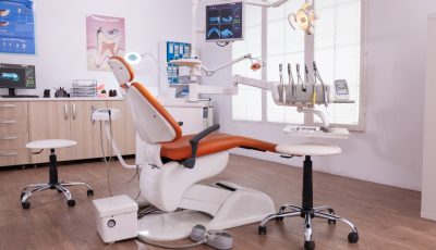 Empty modern teethcare stomatology hospital office with nobody in it equipped with dental intruments ready for orthodontist healthcare treatment. Tooth radiography images on display